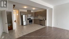 Zorra (Thamesford) townhouse for rent - A spacious kitchen with a refrigerator, oven, and sink.