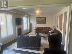 Hamilton (Waterdown) apartment for rent - A living room with a couch, coffee table, and television.