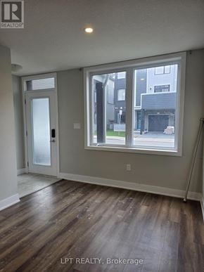 London East (East D) townhouse for rent - A room with wood flooring and a sliding glass door.