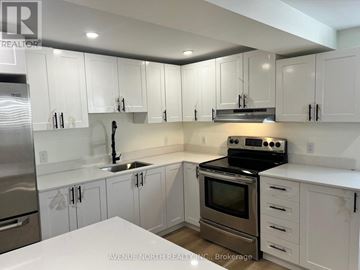 Ottawa apartment for rent - A kitchen with white cabinets and stainless steel appliances.