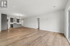 Russell apartment for rent - A room with wooden flooring and white walls, with a logo that reads "REALTOR" in the top left corner.