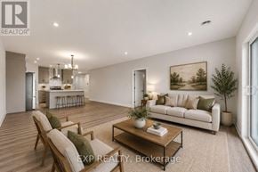 Russell apartment for rent - A modern kitchen with wooden floors and white cabinetry.