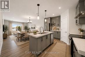 Russell apartment for rent - A modern kitchen with a dining area and a living room with a view of the outdoors.