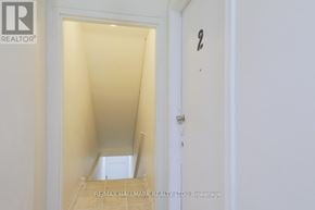 Toronto (East End-Danforth) apartment for rent - A hallway with a door on the right and a staircase on the left.