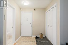 Toronto (East End-Danforth) apartment for rent - A hallway with a white door and a brown paper bag on the floor.