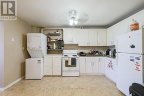 Toronto (East End-Danforth) apartment for rent - A kitchen with white appliances and cabinets.