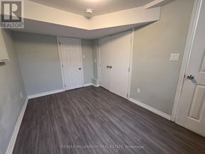 Toronto (L'amoreaux) apartment for rent - A room with wood flooring and white walls.