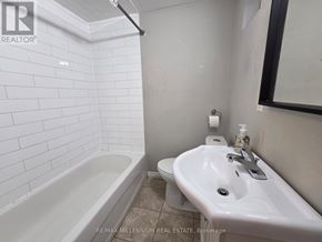 Toronto (L'amoreaux) apartment for rent - A white bathroom with a tub, toilet and sink.