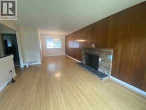 Burnaby apartment for rent - A living room with a fireplace and wooden floors.