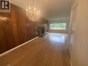 Burnaby apartment for rent - A room with wooden floors and a chandelier.