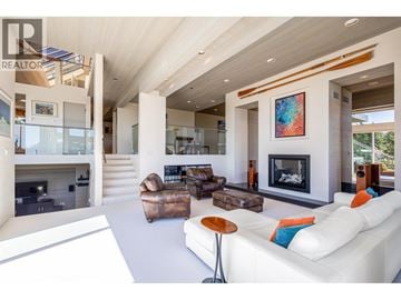 West Vancouver apartment for rent - A modern living room with a fireplace and a painting on the wall.