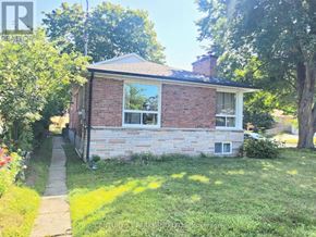 Toronto (West Hill) apartment for rent - A brick house with a white window and a small porch.