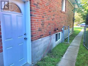 Toronto (West Hill) apartment for rent - A blue door is on the left side of a brick building.