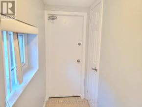Toronto (West Hill) apartment for rent - A white door in a room with a window on the left.