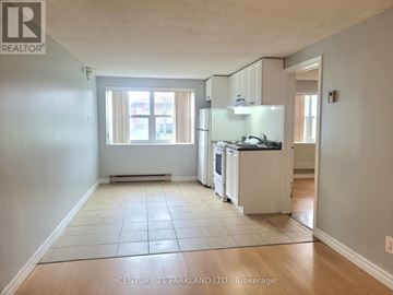 Toronto (West Hill) apartment for rent - A kitchen with white cabinets and a tile floor.