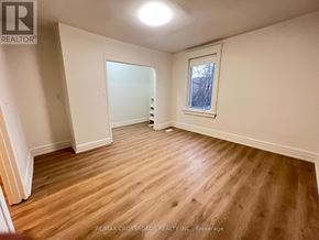 Toronto (South Riverdale) apartment for rent - A room with wooden flooring and a window.