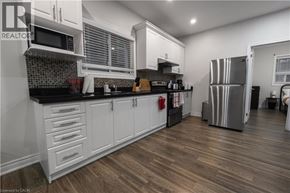 Hamilton apartment for rent - A kitchen with white cabinets and a black countertop.