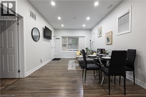 Hamilton apartment for rent - A dining room with a table set for two and a television mounted on the wall.