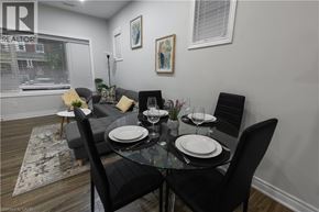 Hamilton apartment for rent - A dining room with a glass table and black chairs.