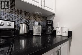 Hamilton apartment for rent - A kitchen counter with a toaster, a coffee maker, and two containers labeled "Coffee Sugar".