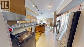 Grande Prairie apartment for rent - A kitchen with a refrigerator, oven, and sink.
