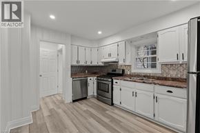 Welland apartment for rent - A kitchen with white cabinets and a refrigerator.