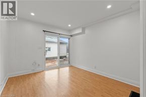 Welland apartment for rent - A room with a sliding glass door leading to a backyard.