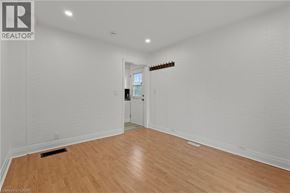 Welland apartment for rent - A room with wooden flooring and white walls.