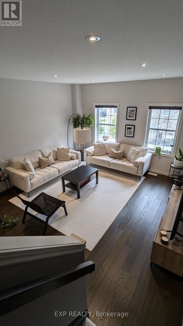 Kitchener townhouse for rent - A living room with a white couch and a coffee table.