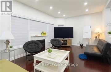 Waterloo apartment for rent - A living room with a black chair and a white coffee table.