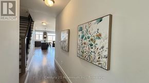 Blue Mountains apartment for rent - A hallway with a painting on the wall and a logo that says REALTOR.