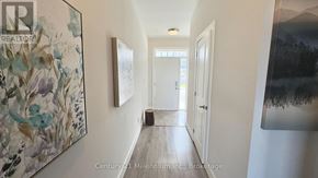 Blue Mountains apartment for rent - A hallway with a painting on the wall and a door at the end.