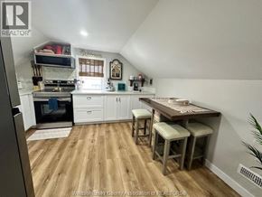 Belle River apartment for rent - A kitchen with a wooden floor and white walls.