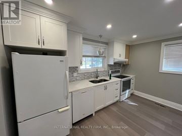 Aurora (Aurora Highlands) apartment for rent - A kitchen with white cabinets and appliances.