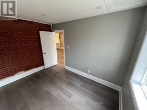 Aurora (Aurora Highlands) apartment for rent - A room with a brick wall and a white door.
