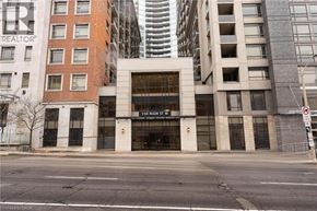 Hamilton condo for rent - A building with a sign that says 150 Main St.