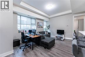 Hamilton condo for rent - A well-lit room with a desk, chair, and a couch.