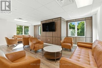 St. Thomas condo for rent - A living room with a television and leather chairs.