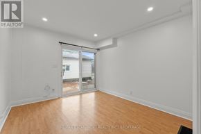 Welland (Prince Charles) multi-family for rent - A room with a sliding glass door leading to a backyard.