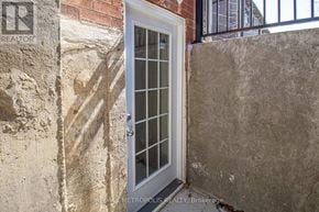 Pickering (Amberlea) apartment for rent - A white door with glass panels is set in a stone wall.