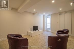 Pickering (Amberlea) apartment for rent - A living room with a brown leather chair and a flat screen TV.