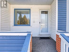 Georgina (Keswick South) apartment for rent - A house with a blue door and a window with a reflection of a tree.