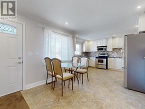 Georgina (Keswick South) apartment for rent - A kitchen with a table and chairs in front of a refrigerator.