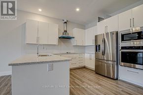 London North (North R) condo for rent - A kitchen with a stainless steel refrigerator, microwave, and oven.