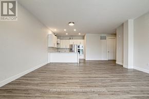 London North (North R) condo for rent - A spacious room with wooden flooring and a white counter in the middle.