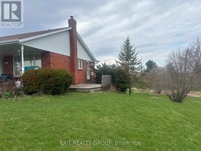 Prince Edward County (Ameliasburg Ward) apartment for rent - A house with a red brick chimney and a white roof is for sale.