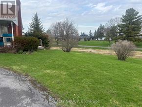 Prince Edward County (Ameliasburg Ward) apartment for rent - A grassy area with a building in the background.