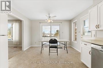 Prince Edward County (Ameliasburg Ward) apartment for rent - A kitchen with a table and chairs in the middle of the room.