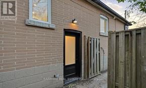 Toronto (Wexford-Maryvale) apartment for rent - A brick house with a black door and a sign that says REALTOR.