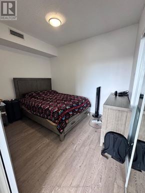 Toronto (Woodbine Corridor) condo for rent - A bedroom with a bed, dresser, and mirror.